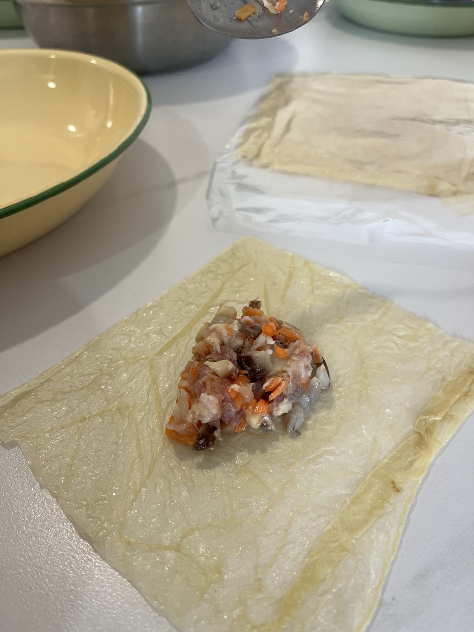 A portion of filling placed on a sheet of beancurd skin, ready to be wrapped.