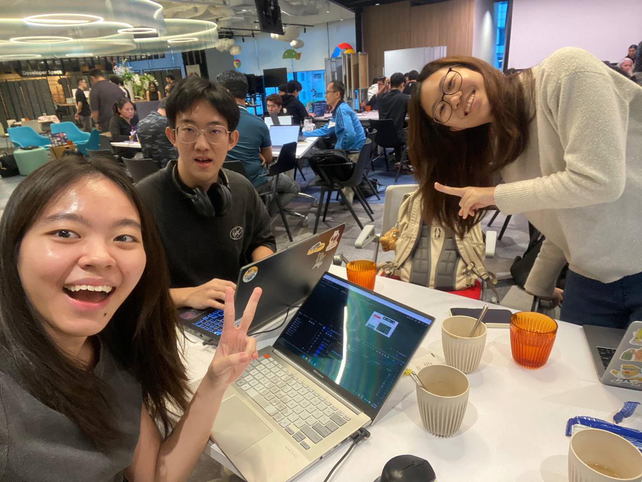 Team photo at the hackathon table, mid-build.